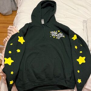 Green hoodie with stars on sleeve. Big bootie land remix merch